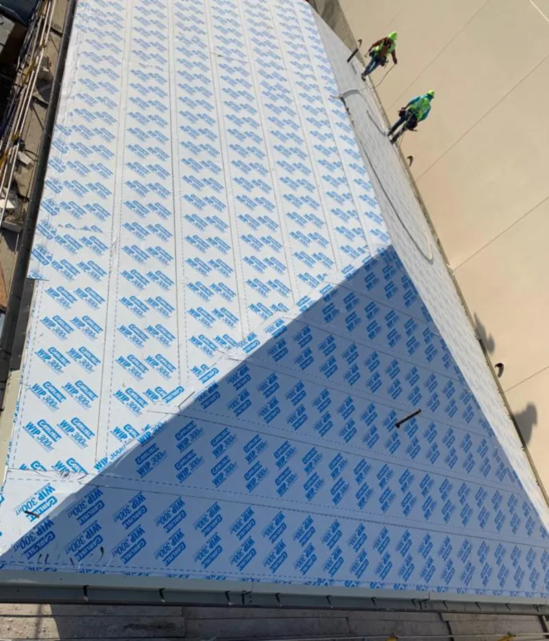 Professional roofers installing underlayment on a metal roof in Benton Park